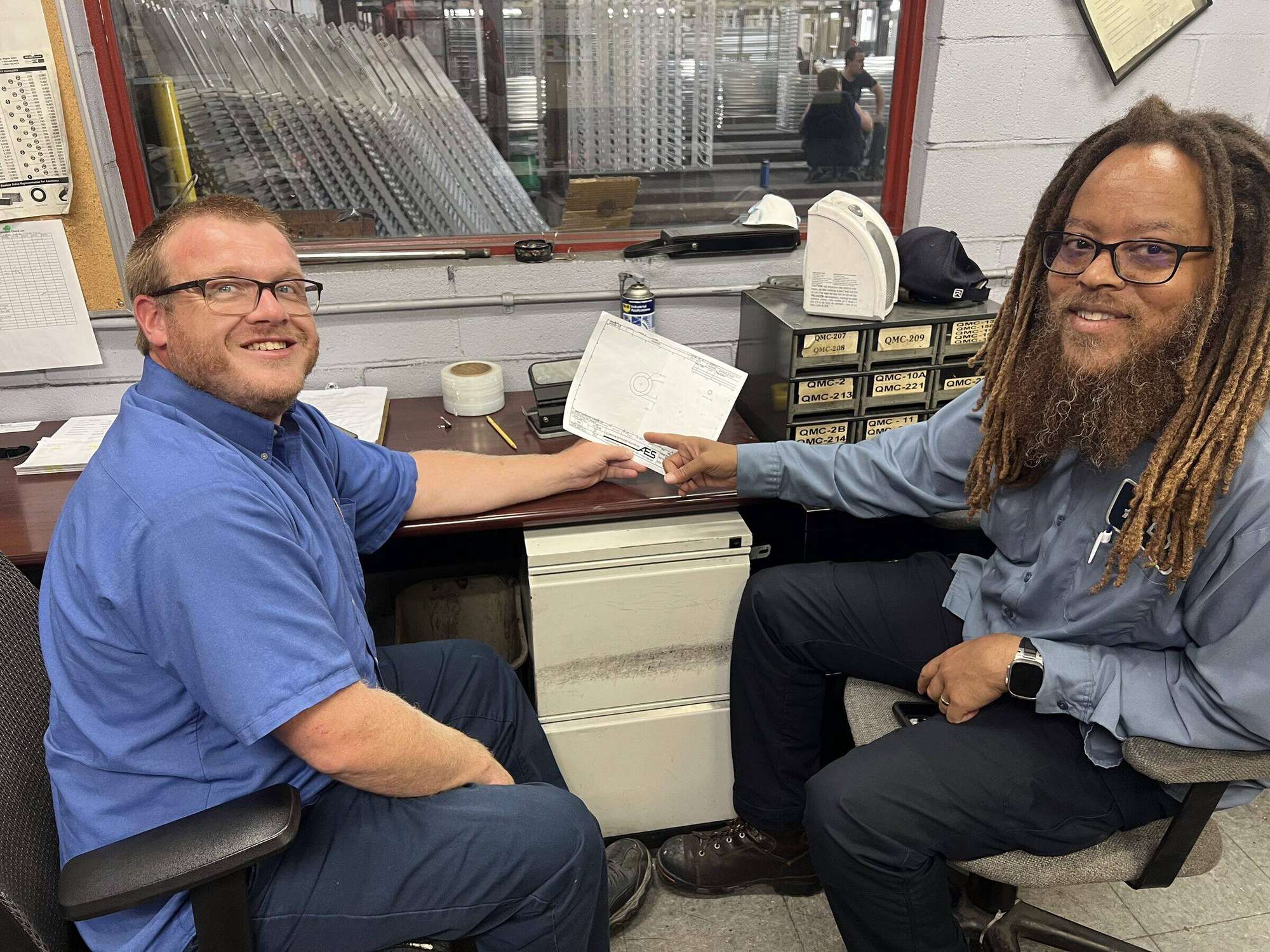 An AES team member working with finished aluminum profiles on the Cincinnati floor