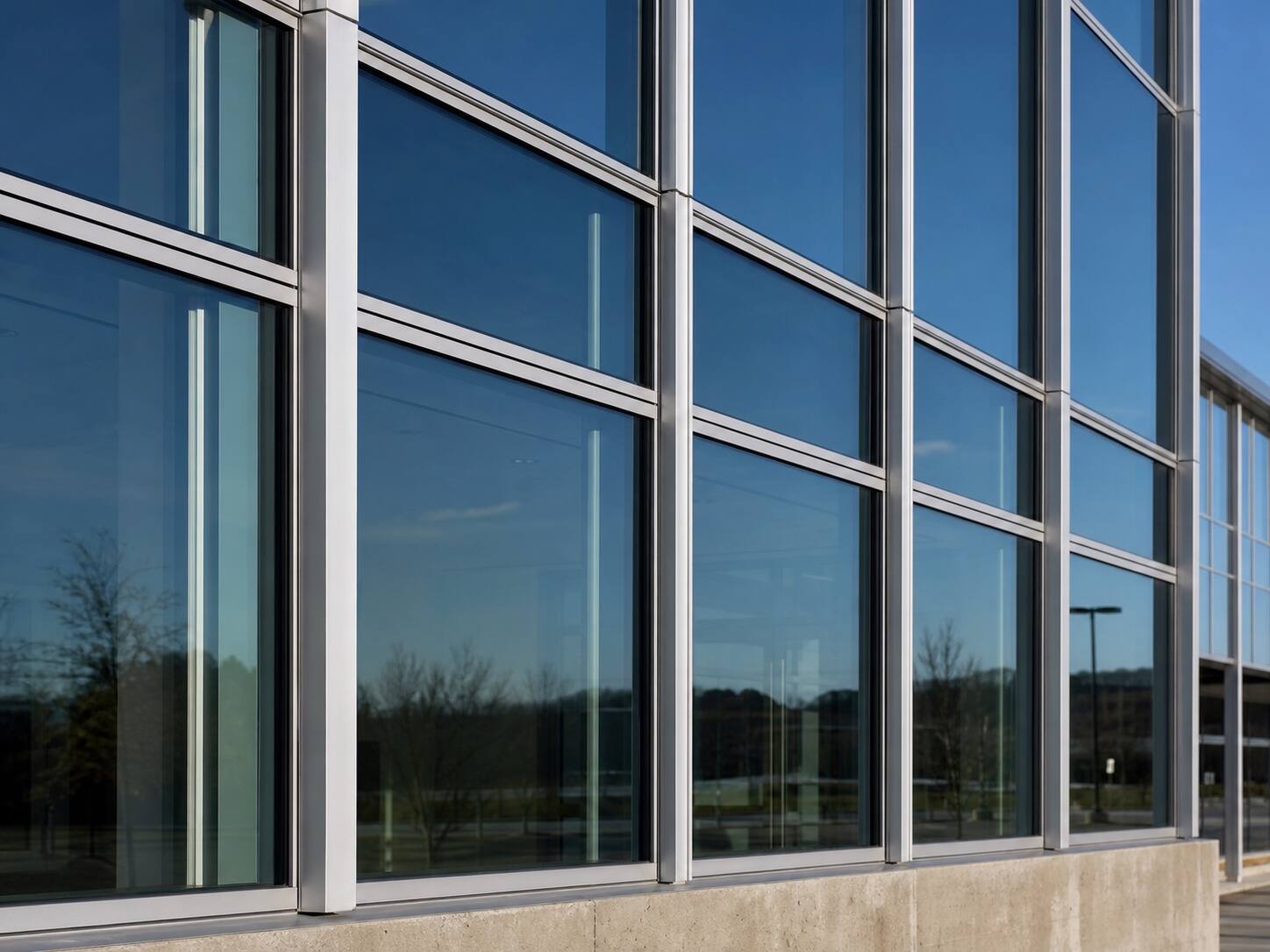 Aluminum curtain-wall mullions holding glass panels on a commercial building facade